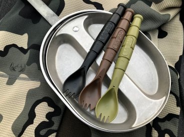 9909MIL: 3 sporks, black, brown, and camo green resting on top of military food tin.